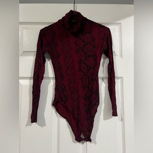 Snake skinned patterned body suit with turtle neck